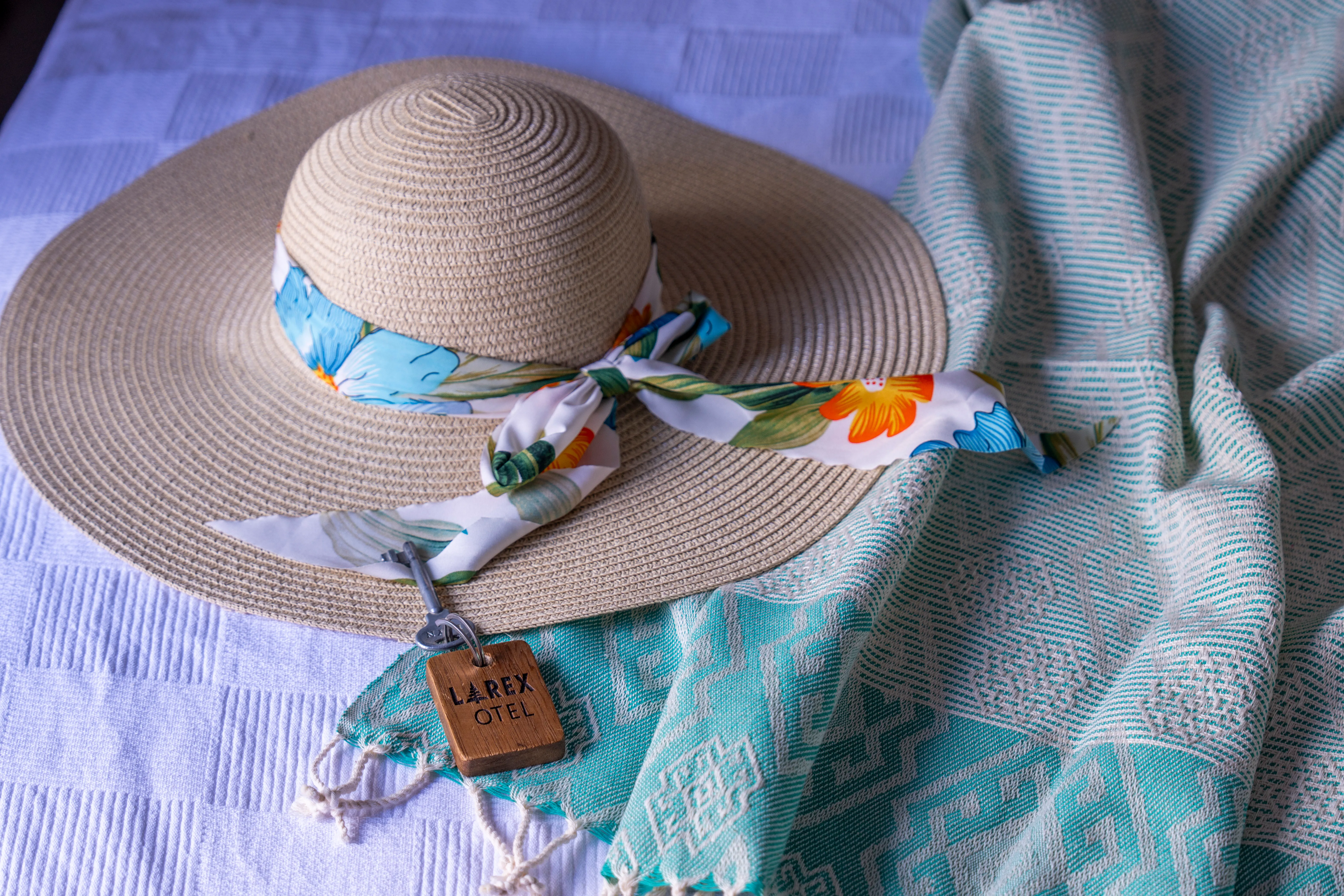 Larex Otel branded straw hat — a welcome detail for guests