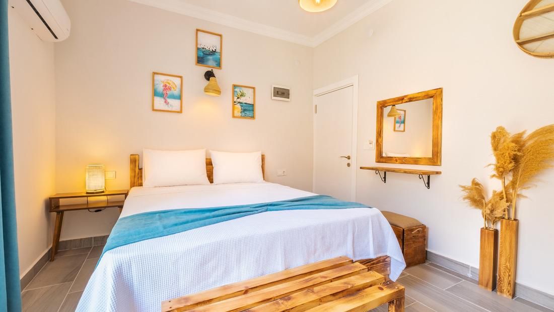 Double room with art prints and natural decor at Larex Pansiyon